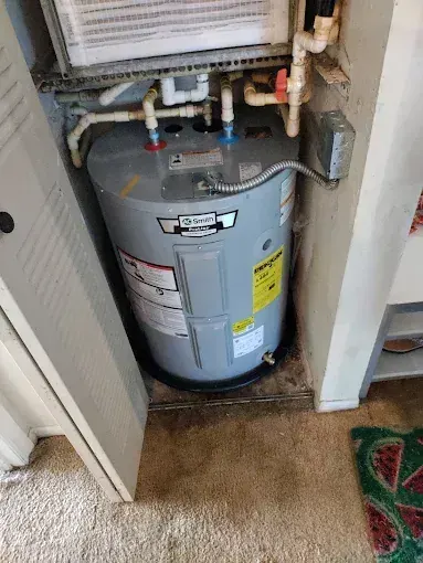 Storage water heater installed in a compact utility closet serving the Schertz, Texas area